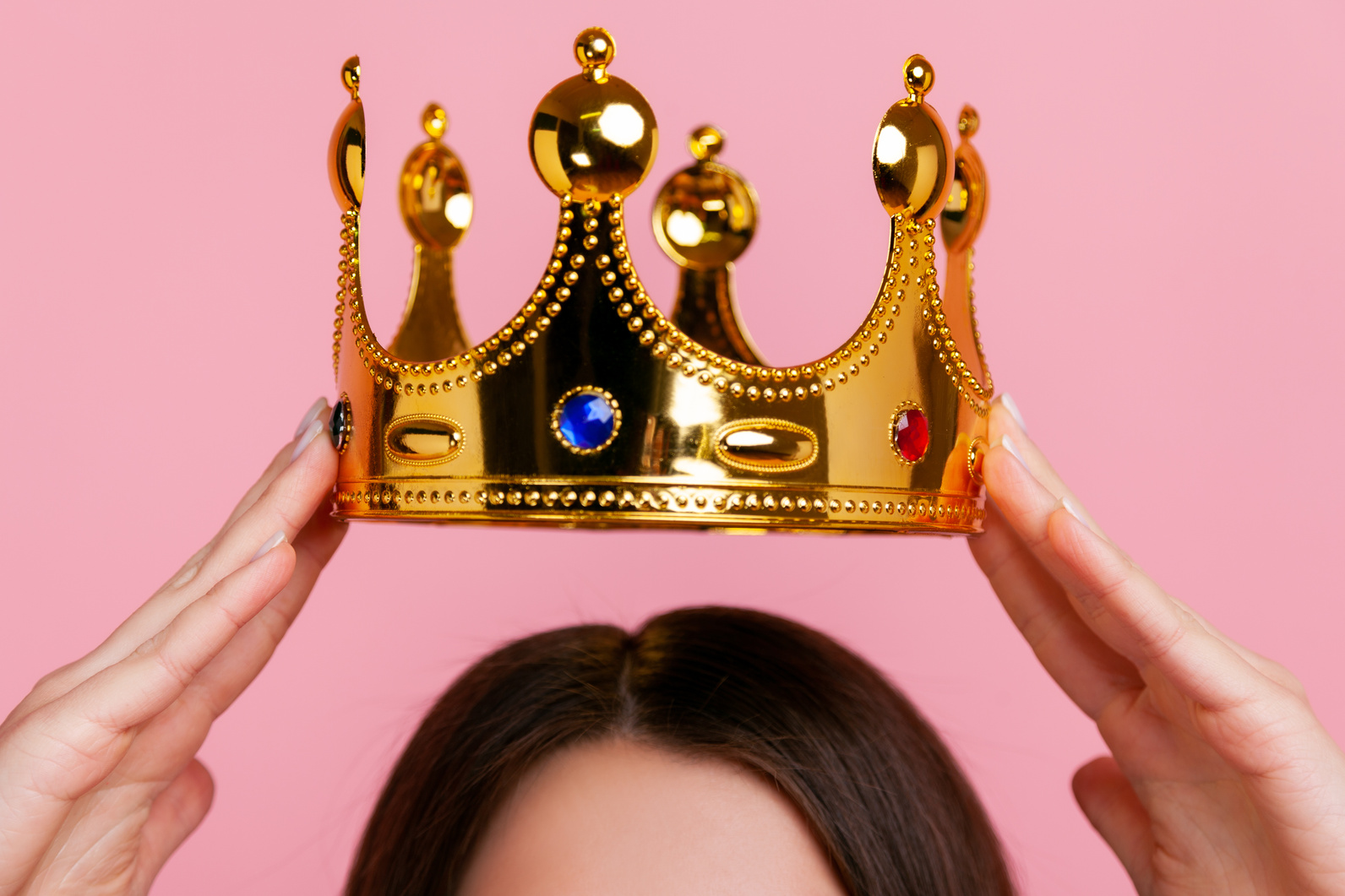 Unknown Brunette Woman Putting on Golden Crown, Arrogance and Privileged Status.