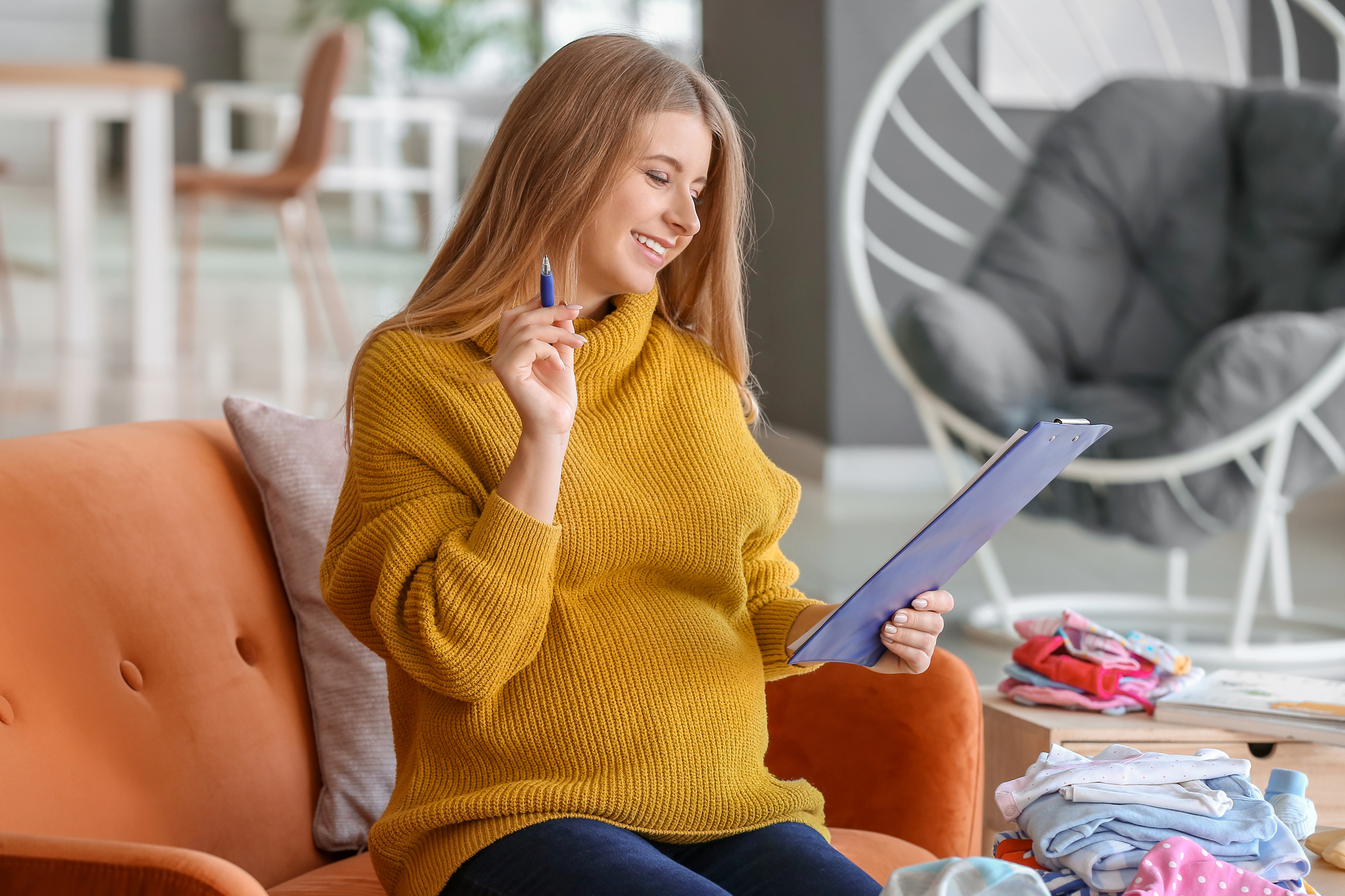 Pregnant Woman Making List of Necessary Things
